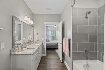 A bathroom with a shower and a sink and a mirror